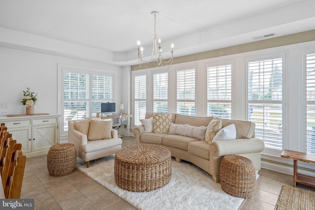 living area featuring a chandelier, light tile patterned floors, and visible vents