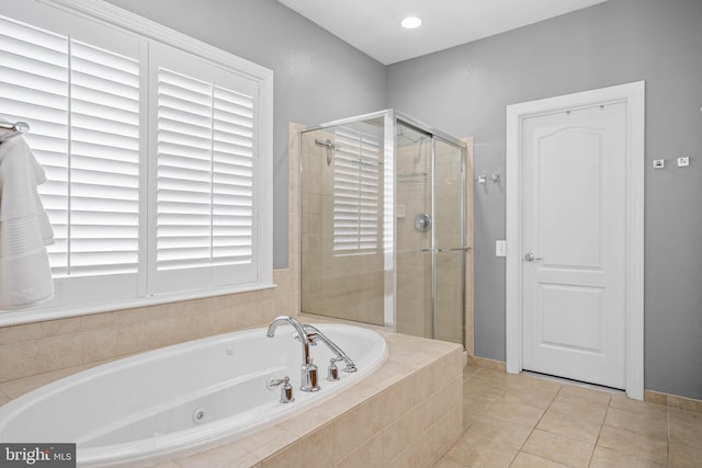 bathroom featuring a whirlpool tub, a shower stall, and tile patterned floors