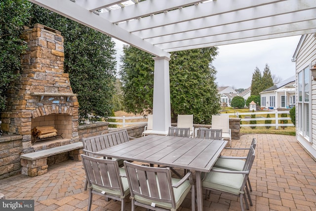 view of patio / terrace with fence, an outdoor stone fireplace, a pergola, and outdoor dining space