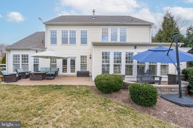 back of property featuring french doors, a patio area, a yard, and outdoor lounge area