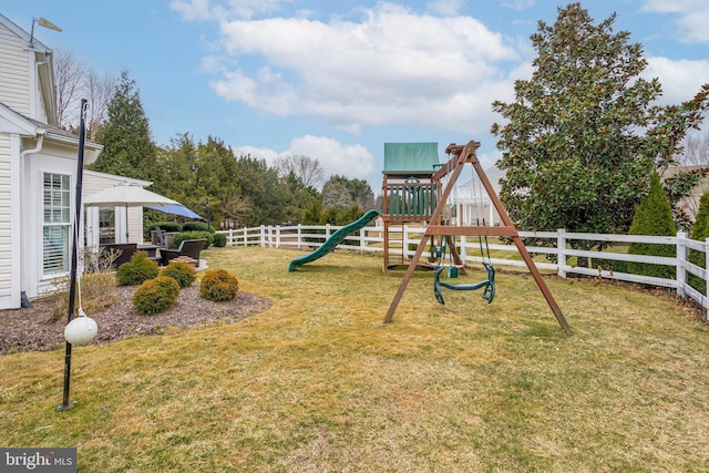 view of play area featuring a lawn and fence