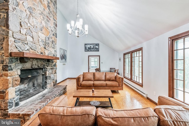 living room with a notable chandelier, a baseboard heating unit, a fireplace, wood finished floors, and baseboards