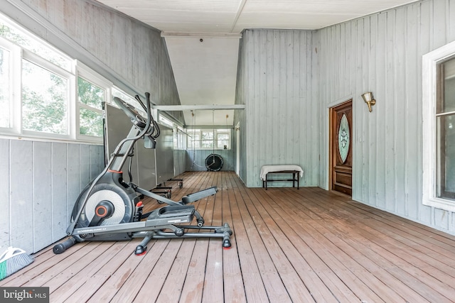 exercise area with wood walls and hardwood / wood-style floors