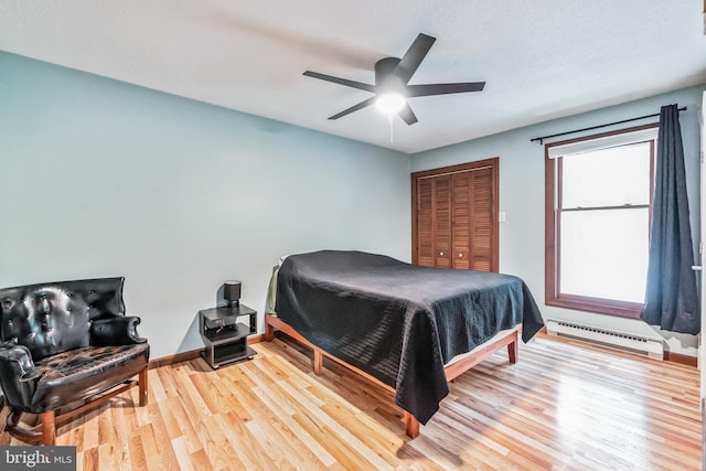 bedroom featuring light wood-style floors, baseboards, ceiling fan, and baseboard heating