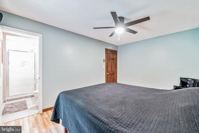 bedroom with a ceiling fan, light wood-type flooring, baseboards, and ensuite bath