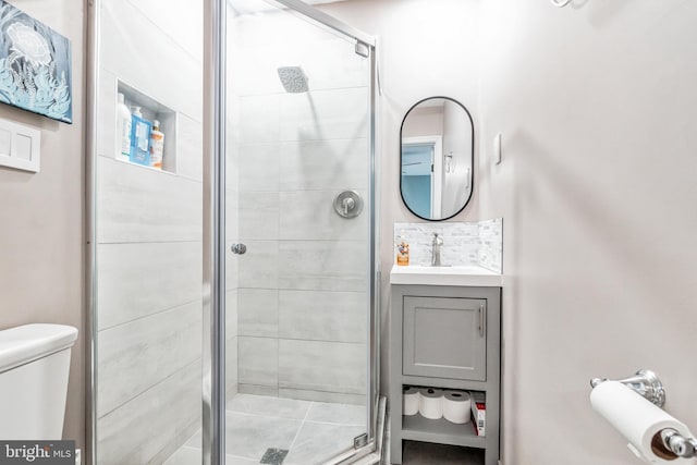 full bath featuring vanity, a shower stall, and toilet