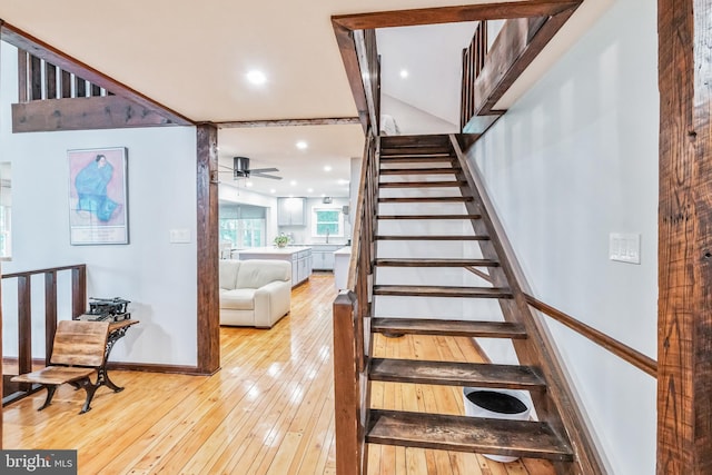 stairway featuring ceiling fan, wood-type flooring, baseboards, and recessed lighting