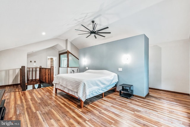 bedroom with vaulted ceiling, a ceiling fan, light wood-style flooring, and baseboards