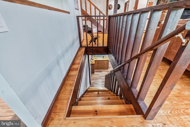 stairway with wood finished floors