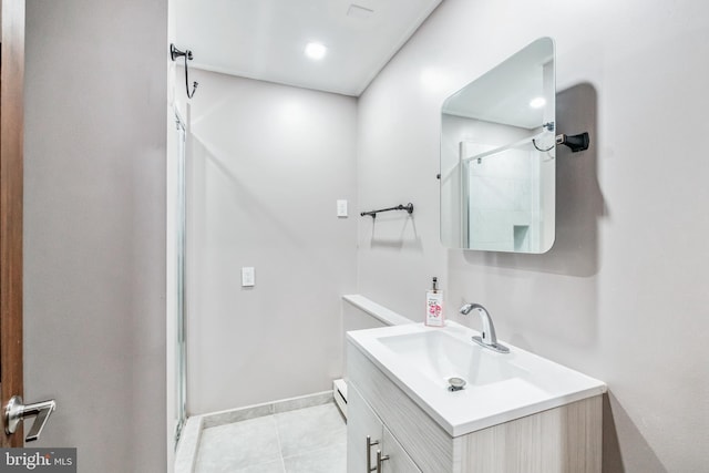 full bath featuring a shower stall, baseboards, tile patterned flooring, and vanity