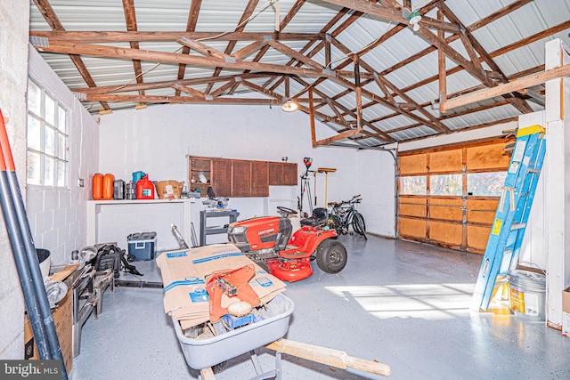 garage featuring concrete block wall and metal wall