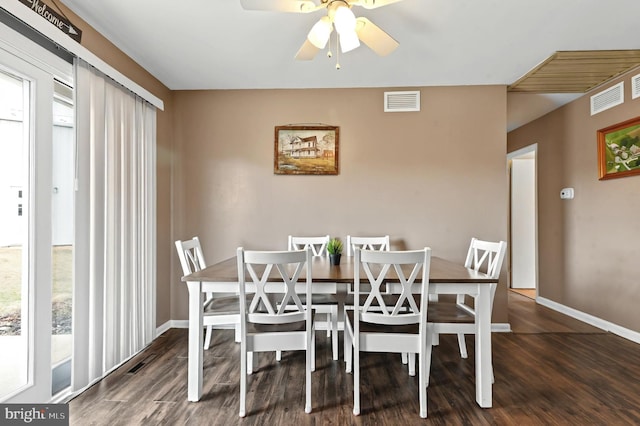 dining area with visible vents, baseboards, and wood finished floors