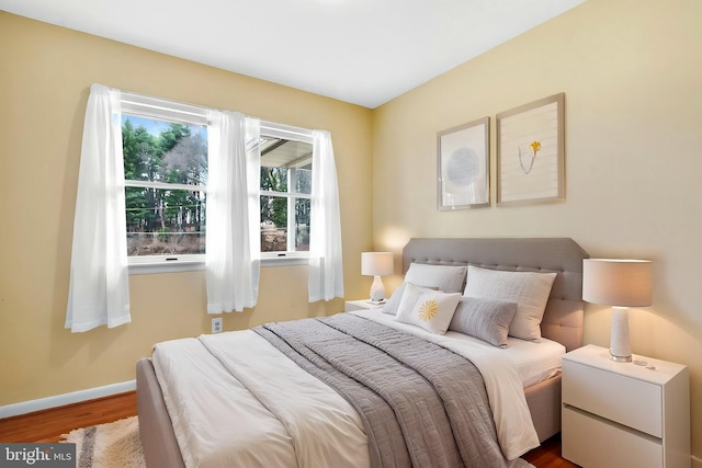 bedroom featuring baseboards and wood finished floors