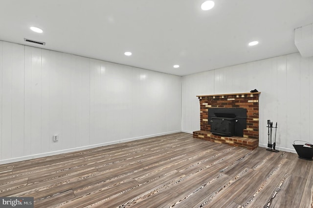 living area with recessed lighting, visible vents, baseboards, and wood finished floors