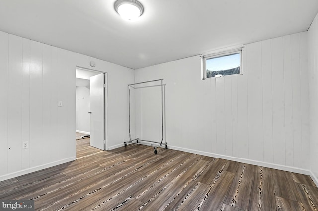 interior space featuring baseboards and wood finished floors