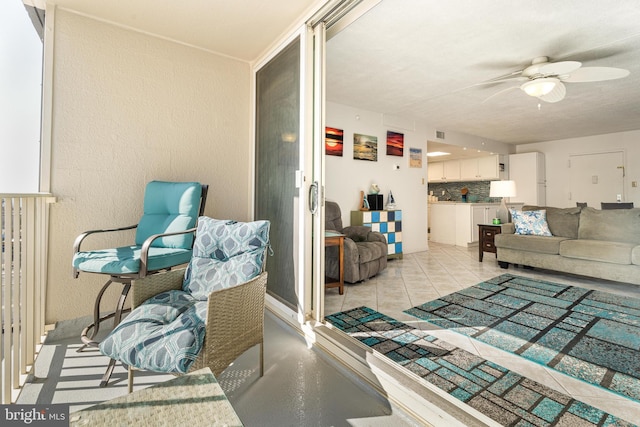 living room featuring light tile patterned floors and ceiling fan