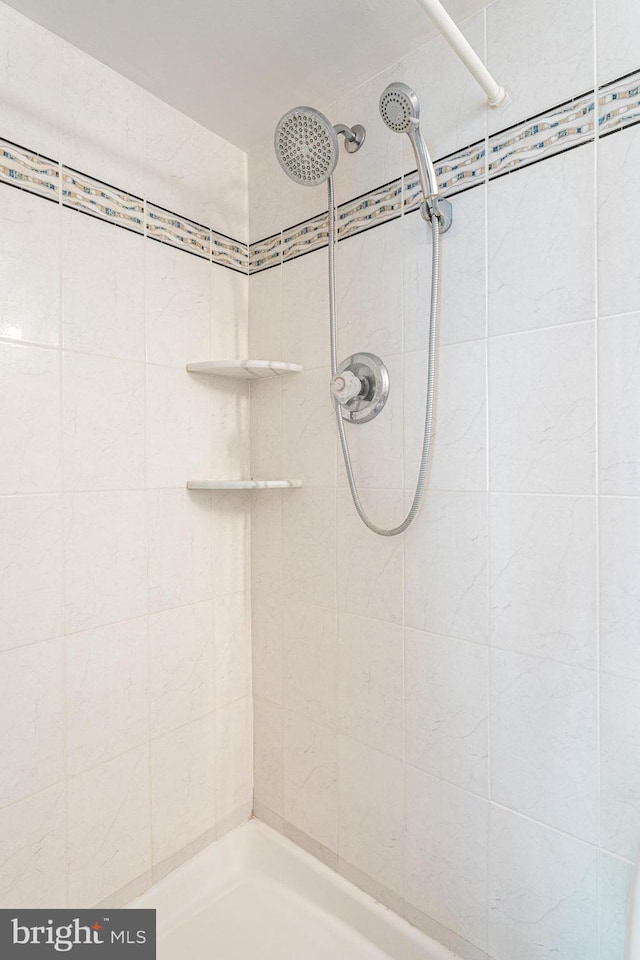 bathroom with tiled shower