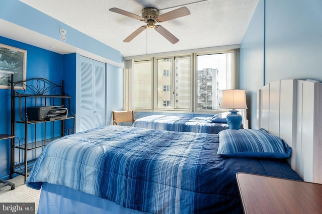 bedroom featuring ceiling fan, a textured ceiling, and a closet