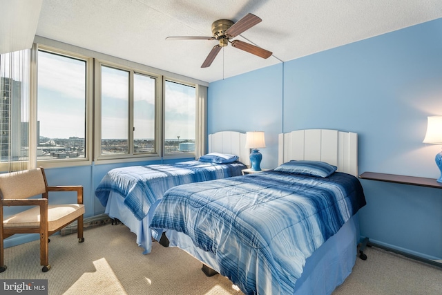 bedroom featuring a textured ceiling, multiple windows, and carpet flooring