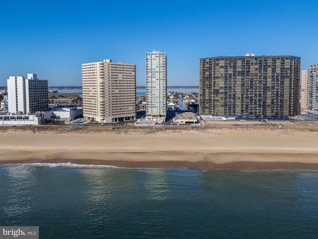 aerial view featuring a beach view, a water view, and a city view