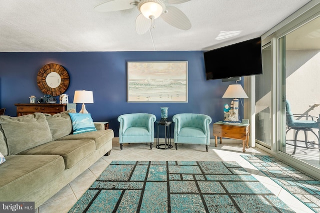 tiled living room featuring ceiling fan, baseboards, and a textured ceiling