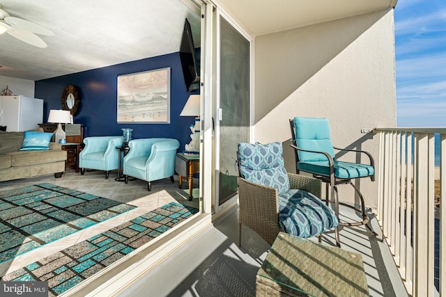 balcony with a patio area and a ceiling fan