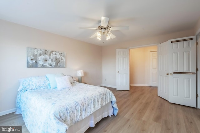 bedroom featuring light wood-type flooring, ceiling fan, and baseboards