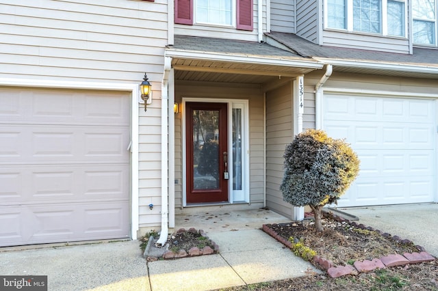 doorway to property featuring a shingled roof