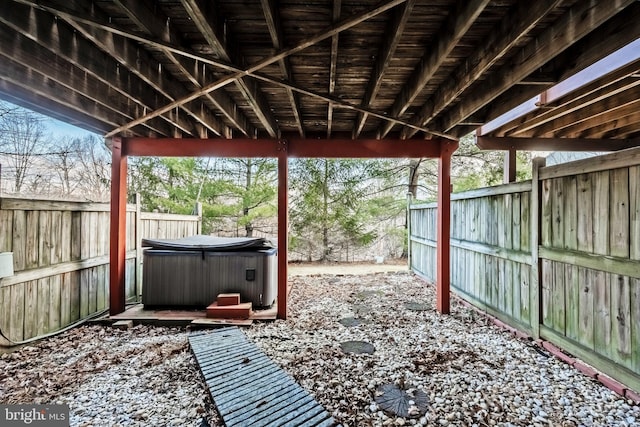 view of patio with a fenced backyard and a hot tub