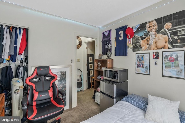 carpeted bedroom featuring freestanding refrigerator