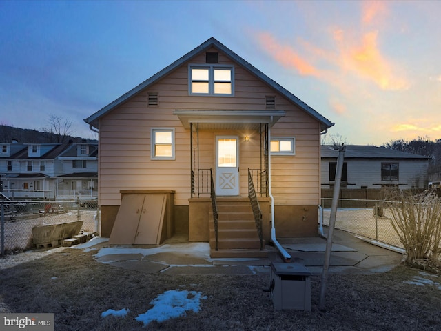 rear view of house with fence