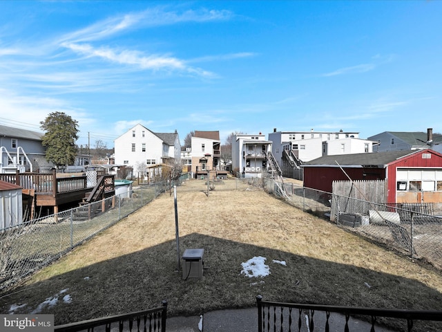 view of yard featuring fence and a residential view