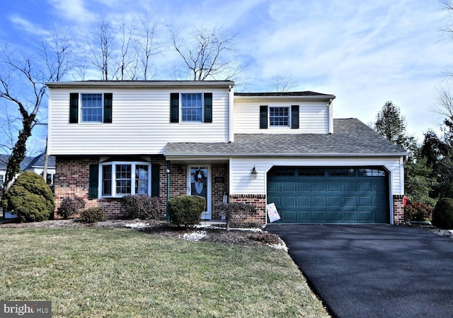 view of front of house featuring roof with shingles, a front lawn, aphalt driveway, and brick siding