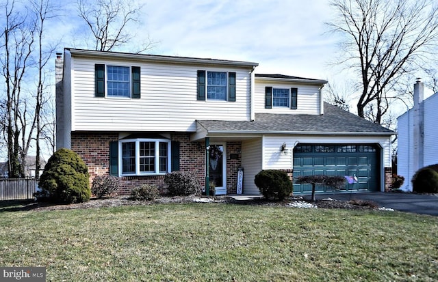 view of front facade with brick siding, aphalt driveway, an attached garage, fence, and a front yard