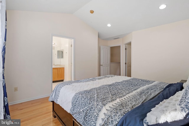 bedroom with lofted ceiling, light wood-style flooring, baseboards, and recessed lighting