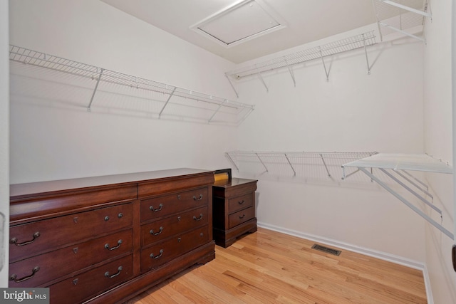 spacious closet featuring attic access, visible vents, and light wood-style flooring