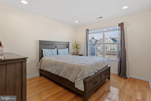 bedroom with light wood-type flooring, visible vents, baseboards, and recessed lighting