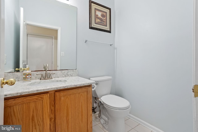 bathroom with toilet, tile patterned flooring, and vanity