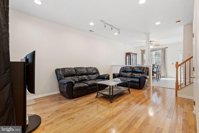 living area with light wood finished floors, recessed lighting, visible vents, baseboards, and stairs