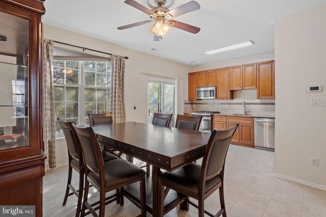 dining room featuring ceiling fan and baseboards