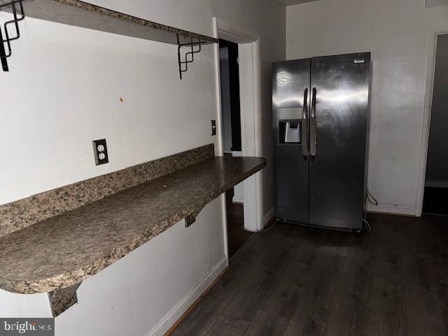 kitchen with dark wood finished floors and stainless steel fridge with ice dispenser