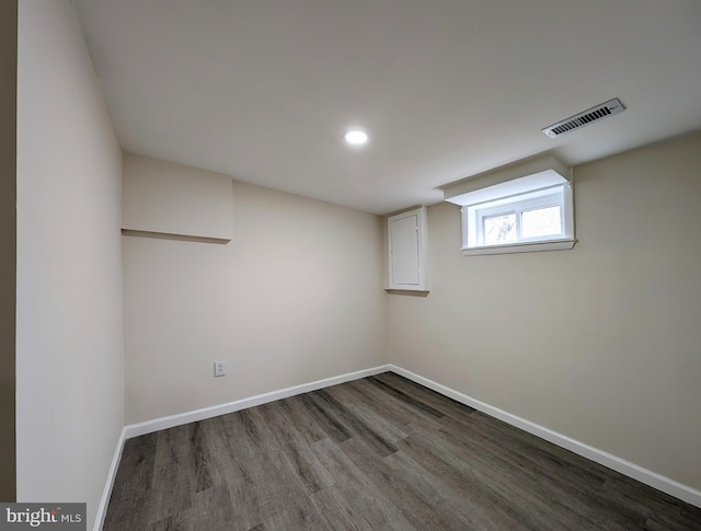 below grade area featuring baseboards, visible vents, wood finished floors, and recessed lighting