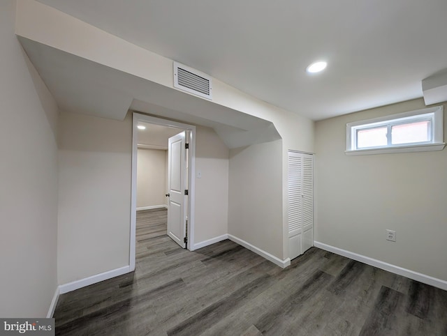 below grade area with baseboards, visible vents, wood finished floors, and recessed lighting