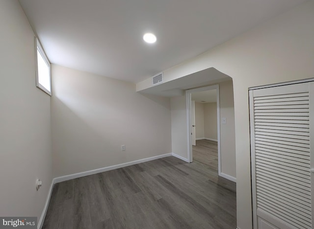 interior space with a closet, wood finished floors, visible vents, and baseboards