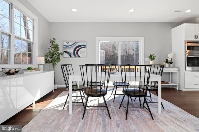 dining room with dark wood-style flooring and recessed lighting