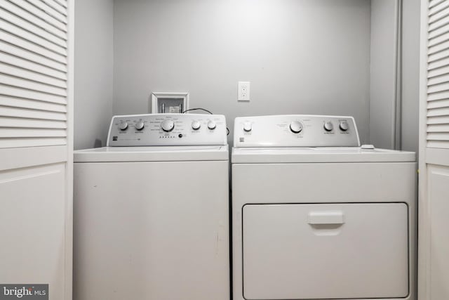 clothes washing area with laundry area and washing machine and clothes dryer