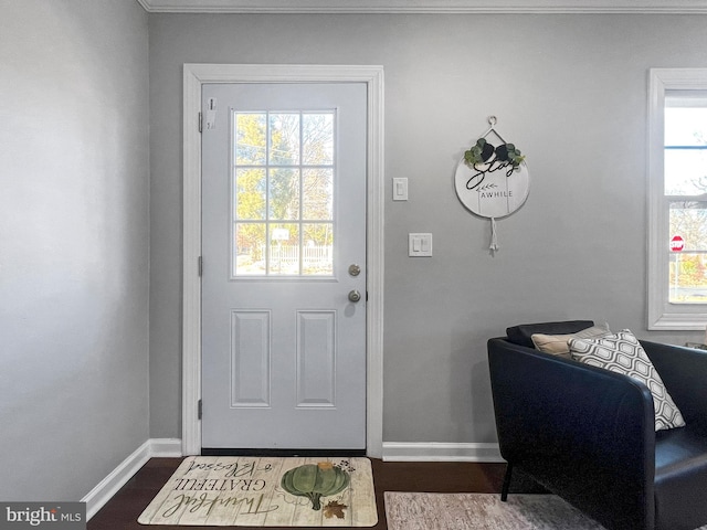 doorway to outside with a healthy amount of sunlight, dark wood finished floors, and baseboards