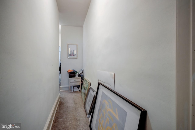 hallway with light carpet and baseboards