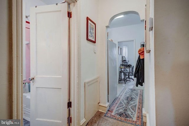 hallway featuring arched walkways