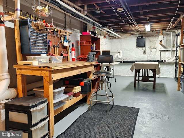 unfinished basement with a workshop area